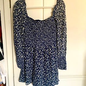 Reformation mini dress with smocked top and puff sleeves with smocking at wrist.